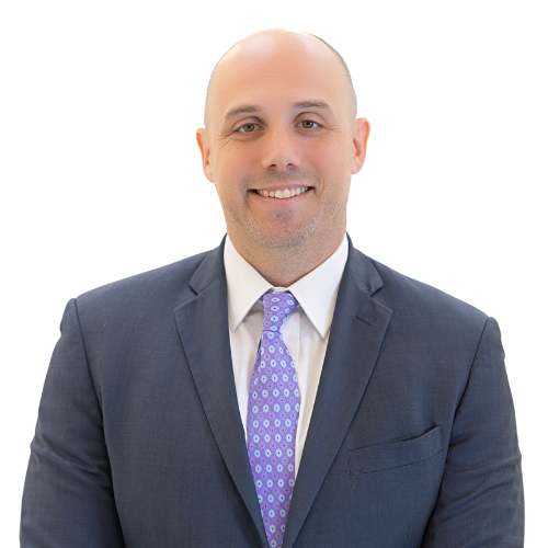 Professional headshot of attorney Jesse Cloyd wearing a dark suit, white shirt, and patterned purple tie, smiling and facing forward against a light background.
